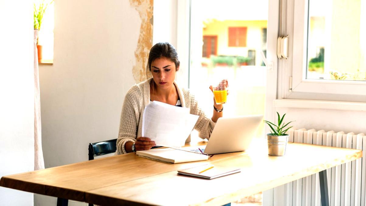 Investment professional reviewing behavioral finance research and emotional decision-making patterns at desk